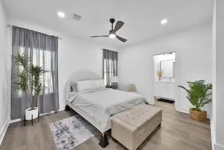 a bedroom with a large bed and a chandelier