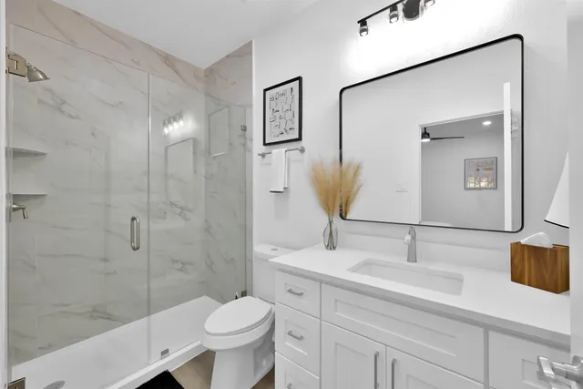 a bathroom with a sink toilet and shower