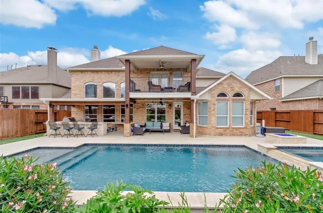an aerial view of a house with swimming pool garden and patio