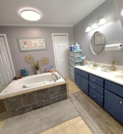a spacious bathroom with a double vanity sink and a mirror