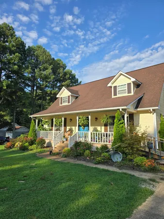 a front view of a house with a yard table and chairs