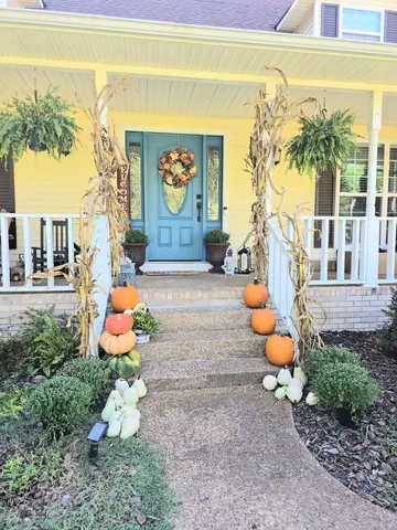 a view of a kitchen with kitchen island stainless steel appliances wooden floor dining table and chairs