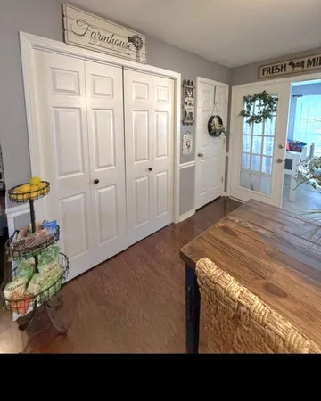 a view of a livingroom with wooden floor and a window