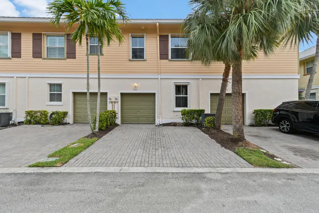 a view of a garden with a table and chairs under an umbrella