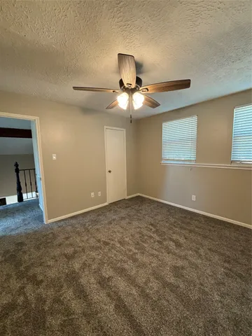 a view of a livingroom with a chandelier fan