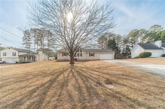 a view of a house with large area and large tree