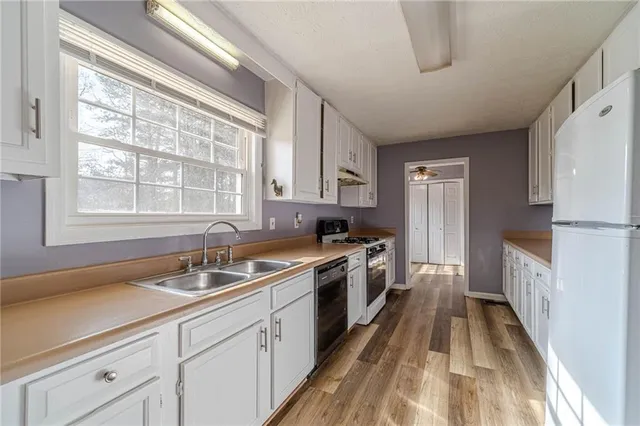 a kitchen with a sink stove and refrigerator