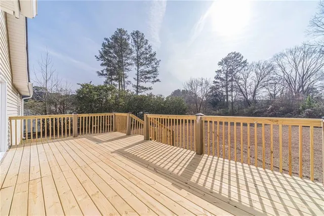 a balcony with wooden floor and fence