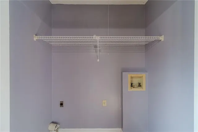 a view of a room with a window and ceiling fan