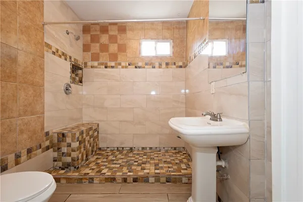 a bathroom with a sink toilet and shower