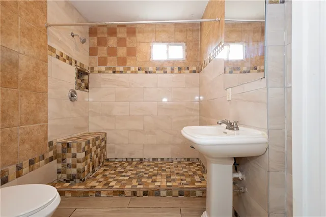 a bathroom with a sink toilet and shower