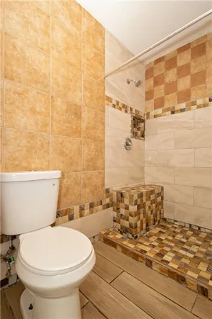 a bathroom with a toilet and a shower