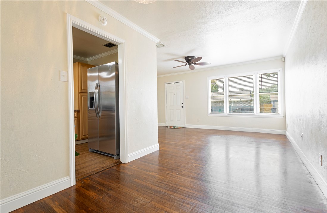 726 Anderson Street Corpus Christi, TX 78411 - Photo 5 of 19 wooden floor in an empty room with a window