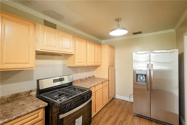 a kitchen with cabinets and a stove top oven
