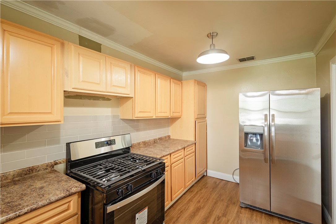 726 Anderson Street Corpus Christi, TX 78411 - Photo 7 of 19 a kitchen with cabinets and a stove top oven