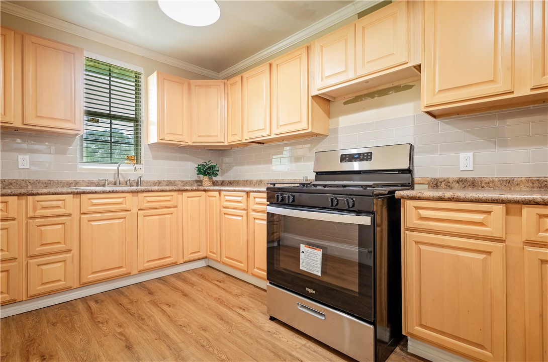 726 Anderson Street Corpus Christi, TX 78411 - Photo 8 of 19 a kitchen with granite countertop white cabinets and white appliances