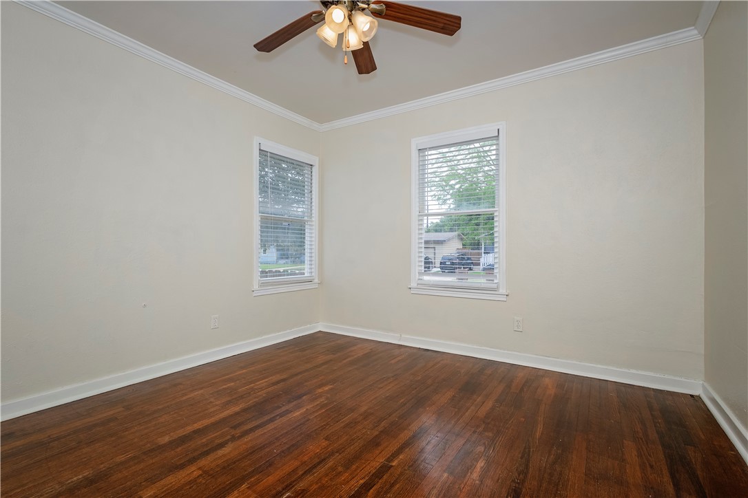 726 Anderson Street Corpus Christi, TX 78411 - Photo 10 of 19 a view of an empty room with wooden floor and a window