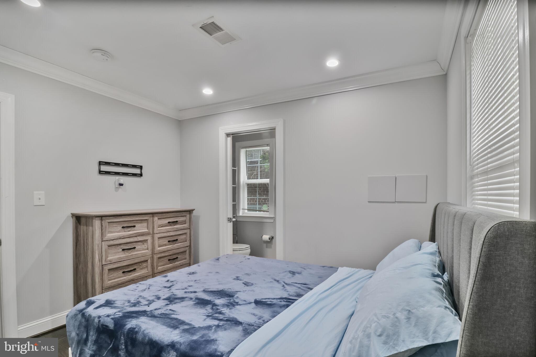 1423 Howard Road Southeast Washington, DC 20020 - Photo 14 of 45 a bedroom with a bed and furniture