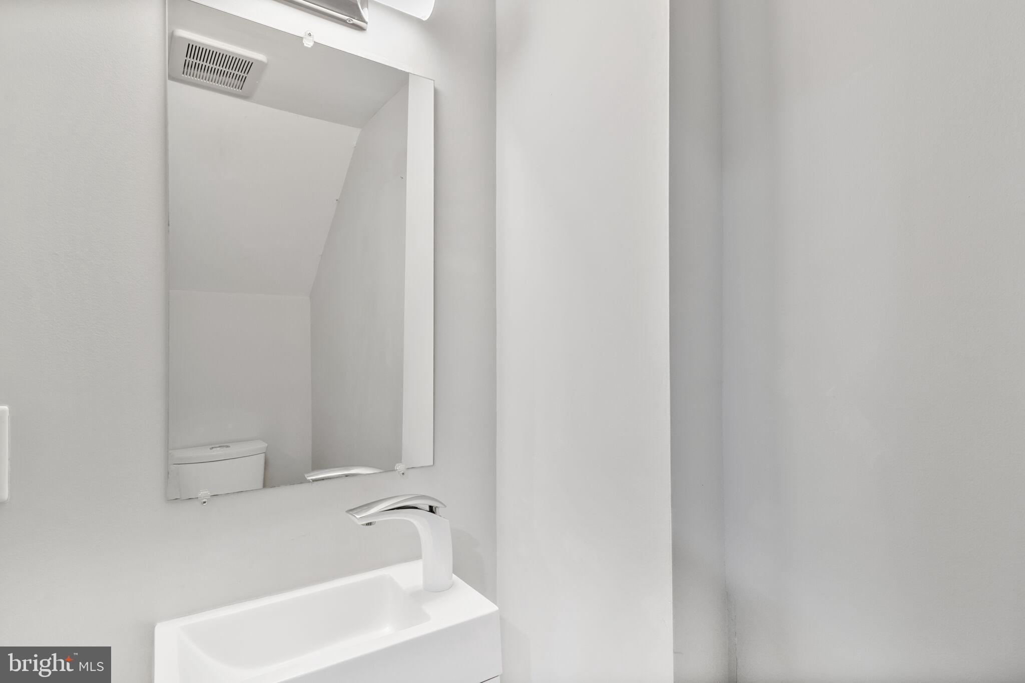 1423 Howard Road Southeast Washington, DC 20020 - Photo 19 of 45 a bathroom with a sink and a mirror