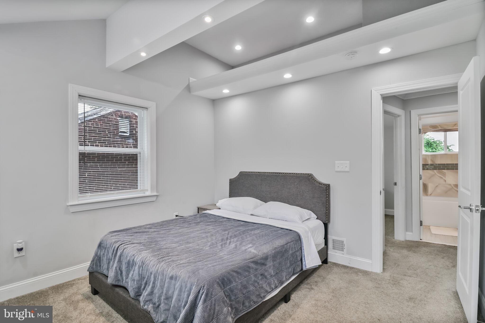 1423 Howard Road Southeast Washington, DC 20020 - Photo 23 of 45 a bedroom with a bed and a painting