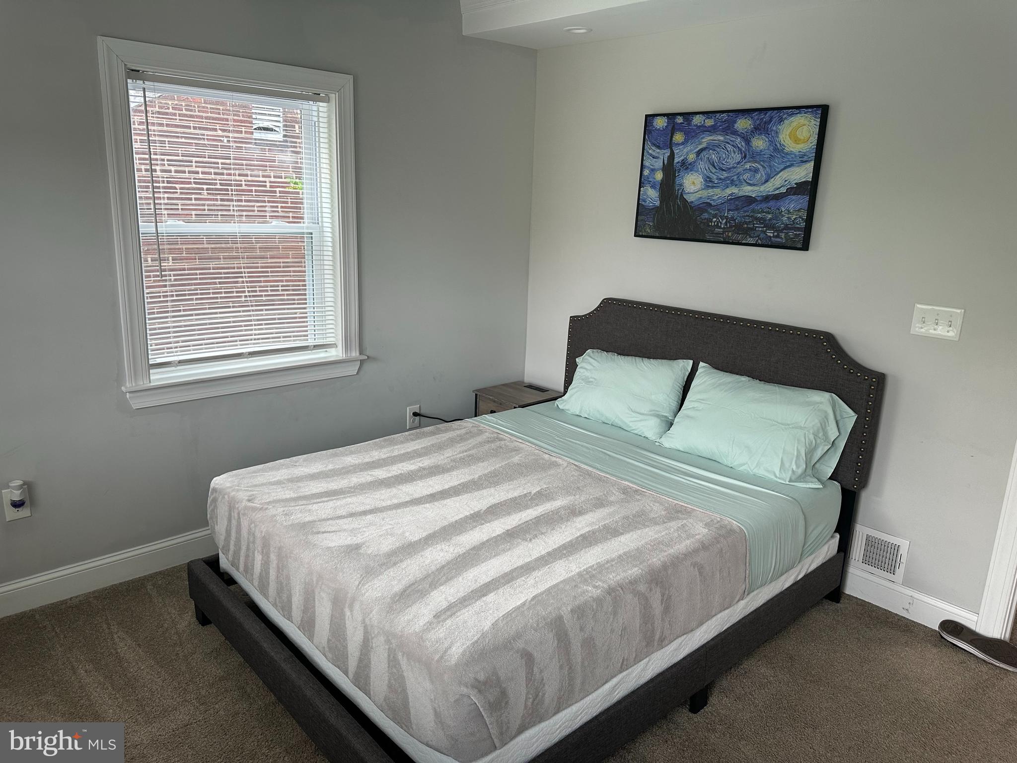 1423 Howard Road Southeast Washington, DC 20020 - Photo 25 of 45 a large bed sitting in a bedroom next to a window