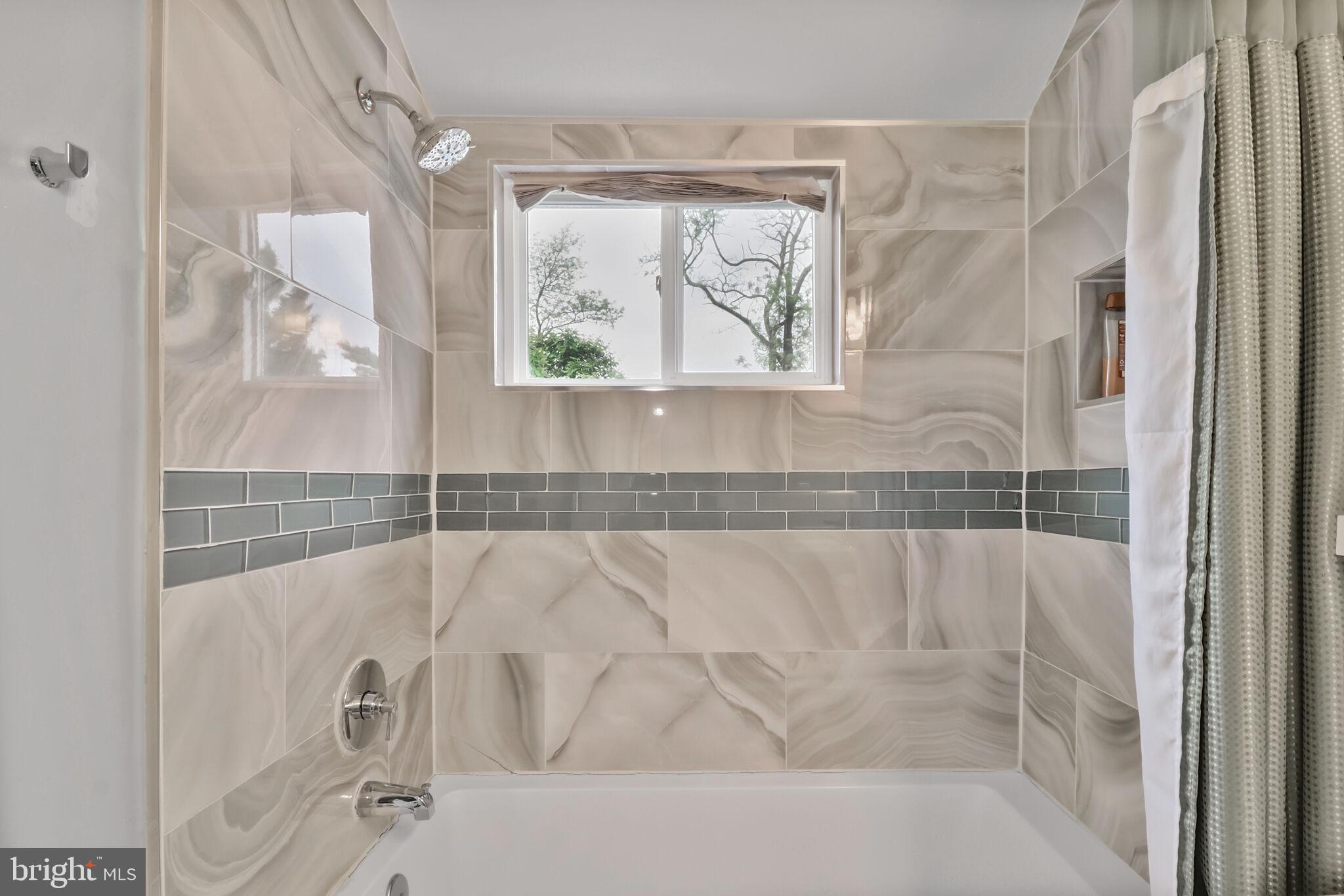 1423 Howard Road Southeast Washington, DC 20020 - Photo 31 of 45 a bathroom with a bathtub and a shower