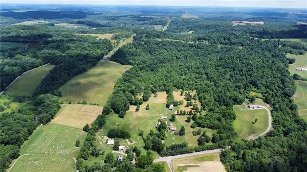 an aerial view of a house with a yard and lake view