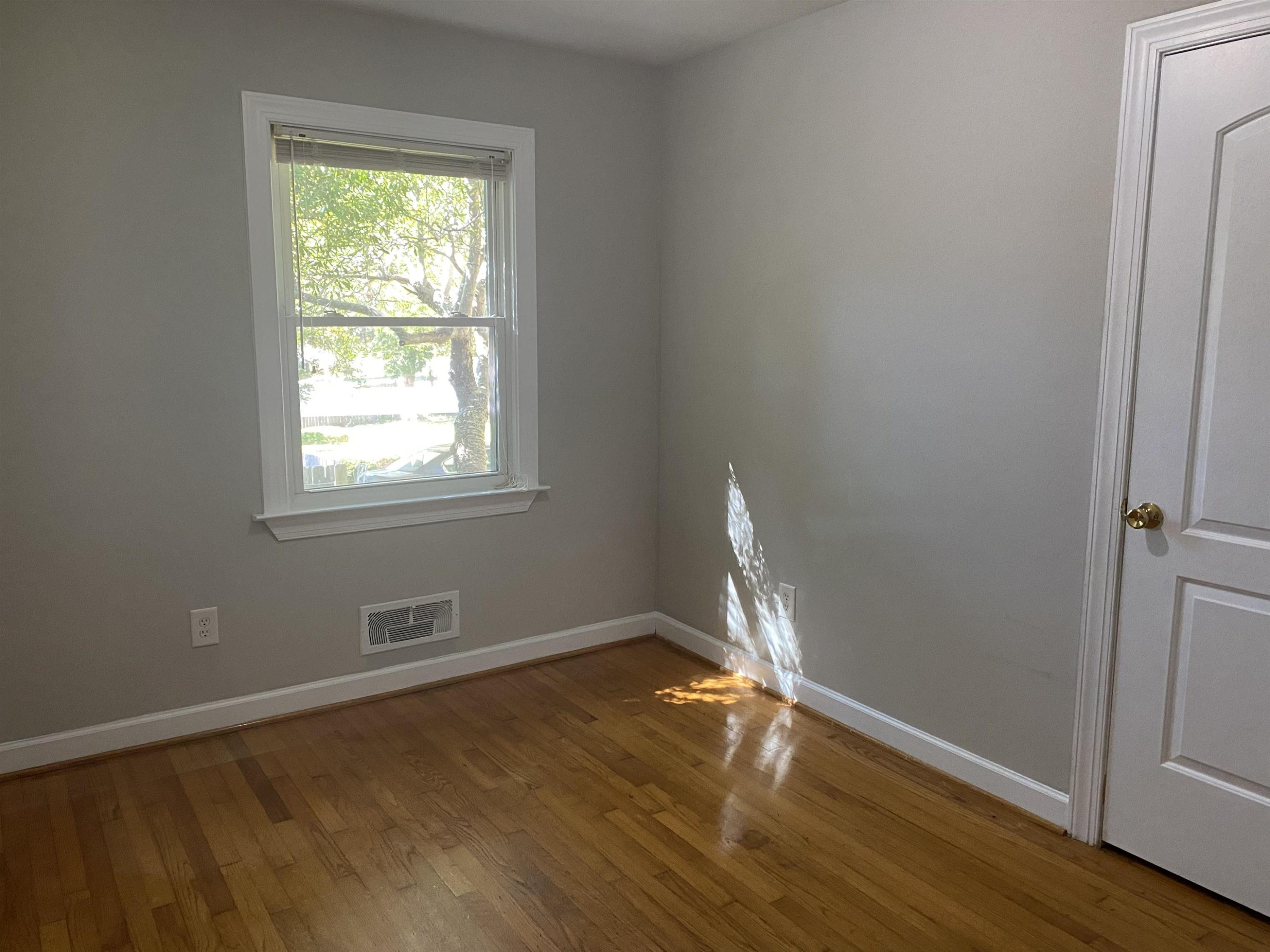 633 Buck Jones Road Raleigh, NC 27606 - Photo 12 of 20 an empty room with wooden floor and windows