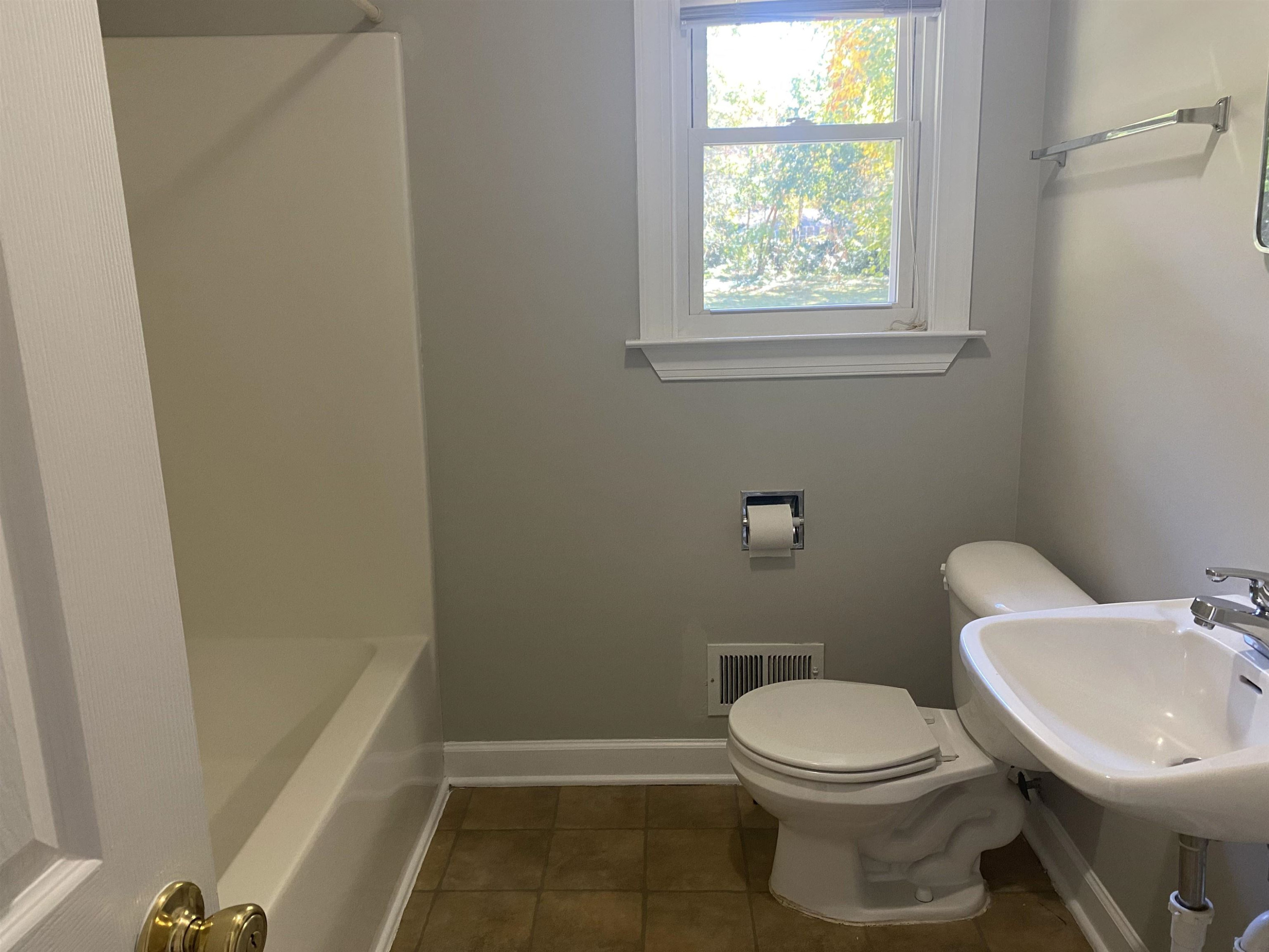 633 Buck Jones Road Raleigh, NC 27606 - Photo 15 of 20 a white toilet sitting next to a bathroom sink