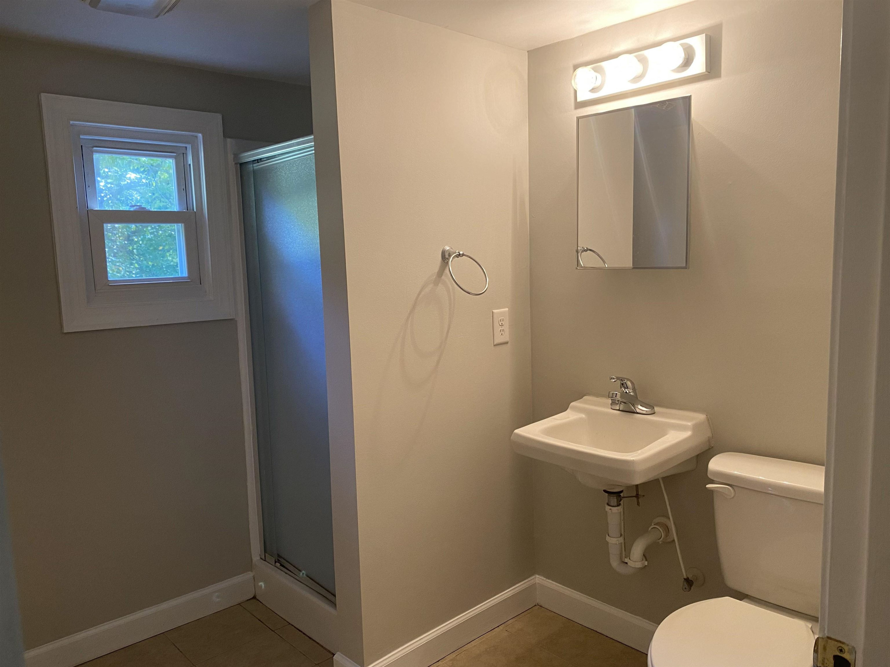 633 Buck Jones Road Raleigh, NC 27606 - Photo 16 of 20 a bathroom with a toilet a sink and mirror