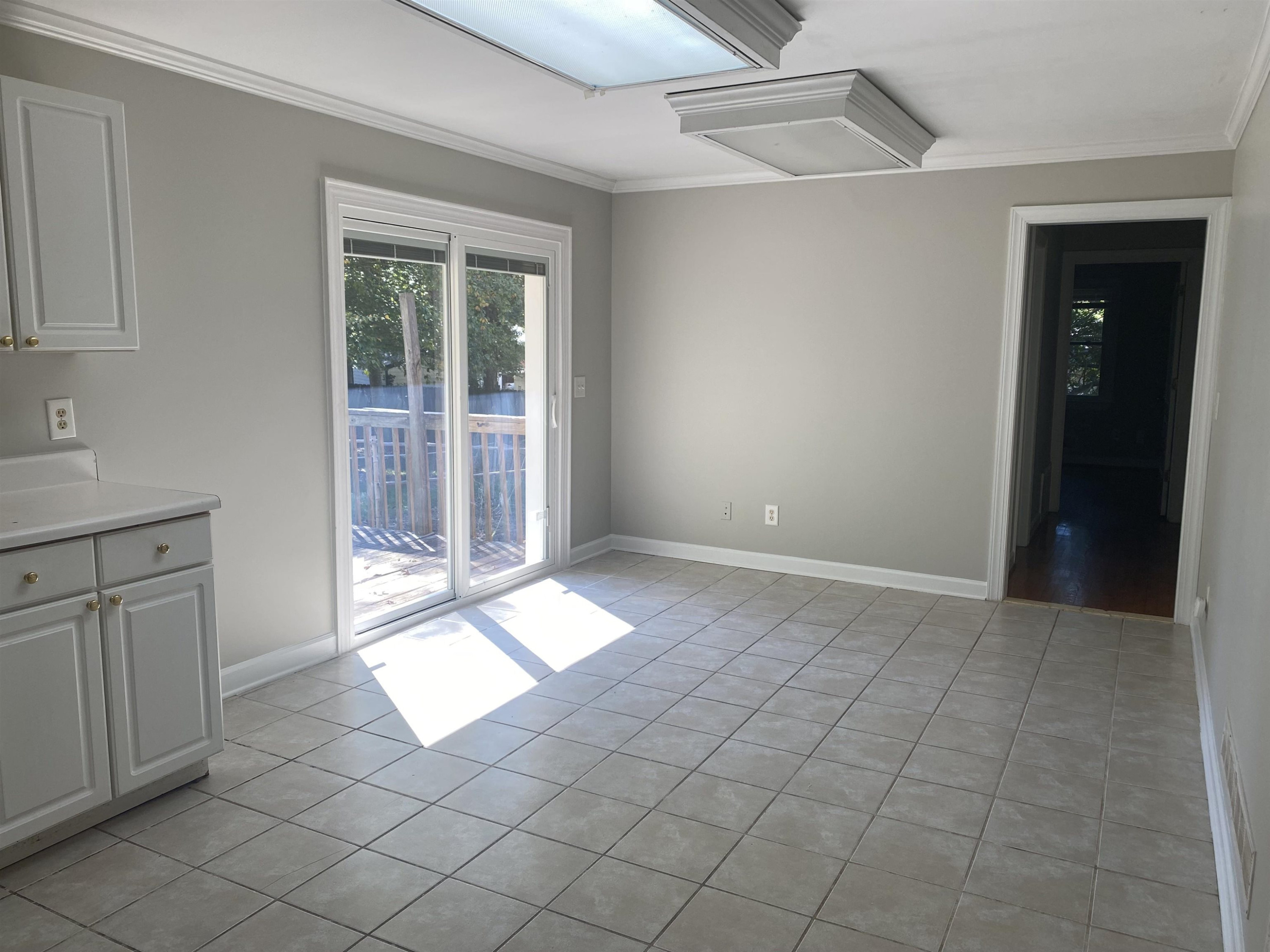 633 Buck Jones Road Raleigh, NC 27606 - Photo 9 of 20 a view of an empty room with window and cabinet
