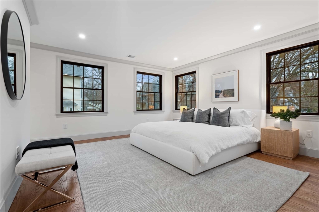 8 Stetson Street Brookline, MA 02446 - Photo 14 of 36 a spacious bedroom with a bed a couch and large window