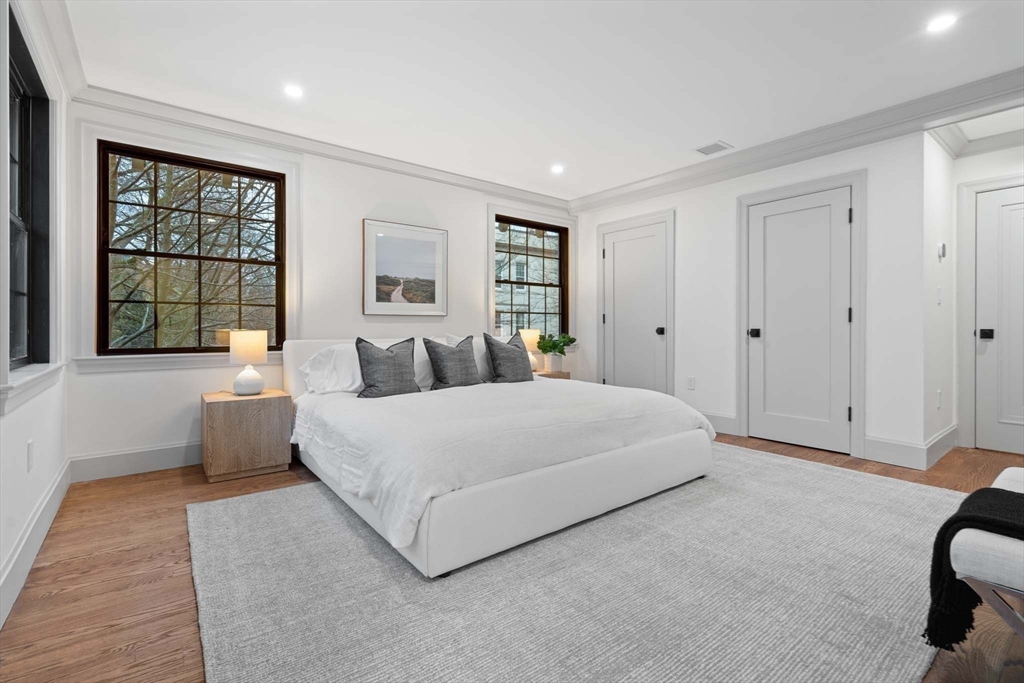 8 Stetson Street Brookline, MA 02446 - Photo 15 of 36 a spacious bedroom with a large bed and a window