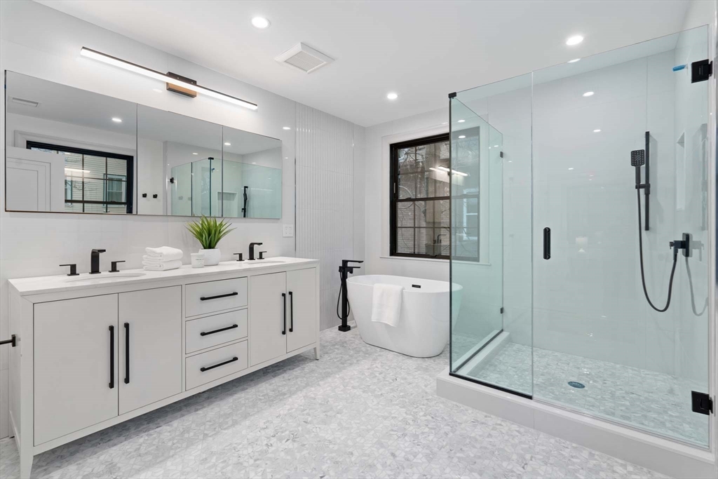 8 Stetson Street Brookline, MA 02446 - Photo 16 of 36 a bathroom with a double vanity sink mirror and shower