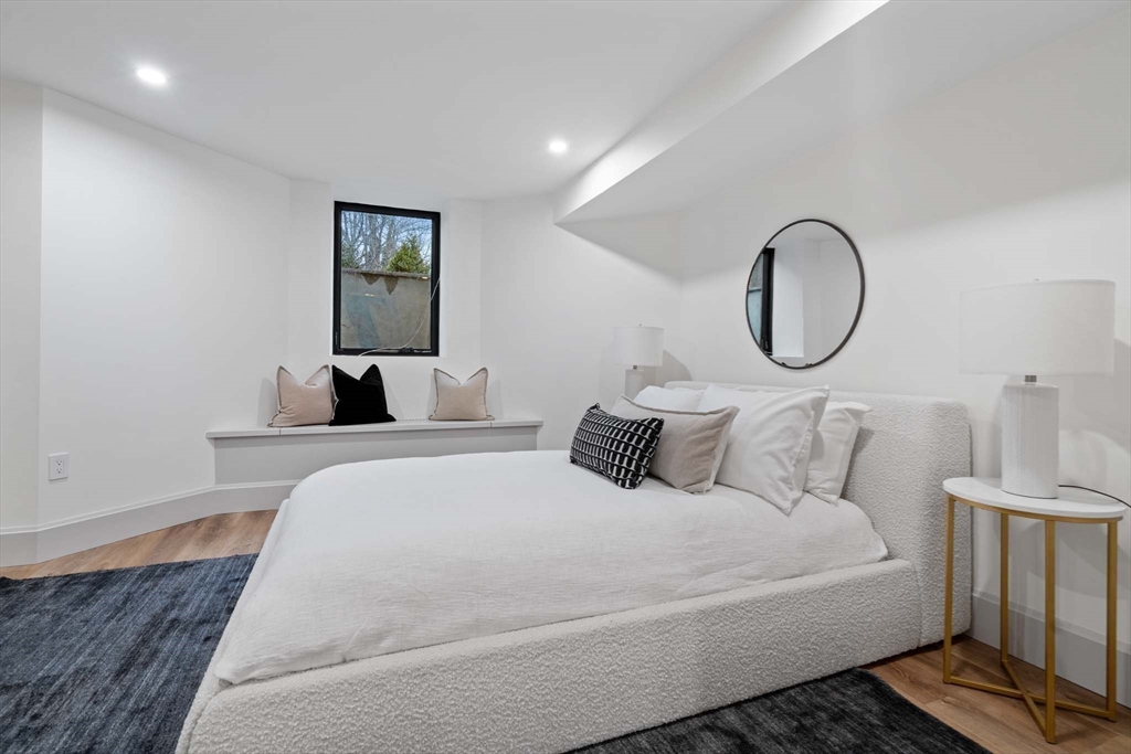 8 Stetson Street Brookline, MA 02446 - Photo 24 of 36 a bedroom with a bed and a lamp with wooden floor
