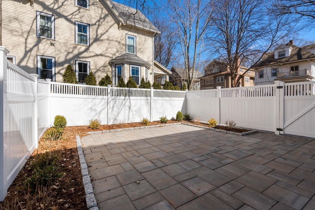 8 Stetson Street Brookline, MA 02446 - Photo 33 of 36 a view of a white house with a yard