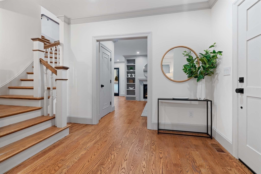 8 Stetson Street Brookline, MA 02446 - Photo 4 of 36 a view of a hallway with wooden floor and entryway
