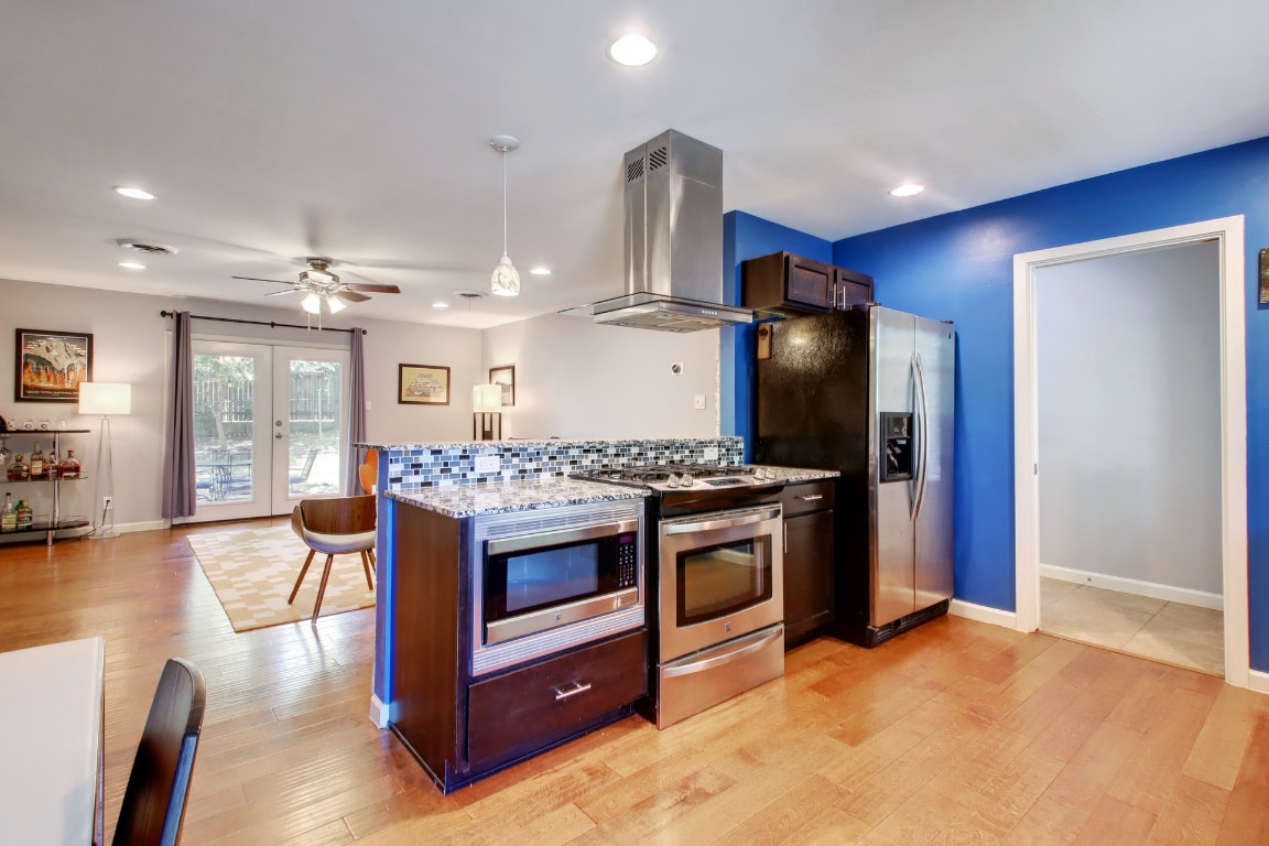 a kitchen with stainless steel appliances granite countertop a stove and a refrigerator