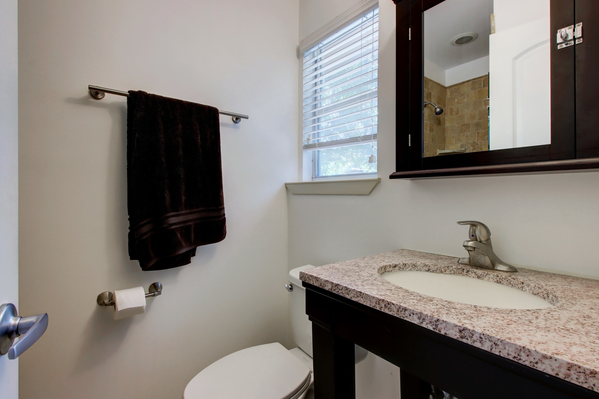6709 Columbia Drive Austin, TX 78723 - Photo 16 of 24 a bathroom with a granite countertop sink and a mirror