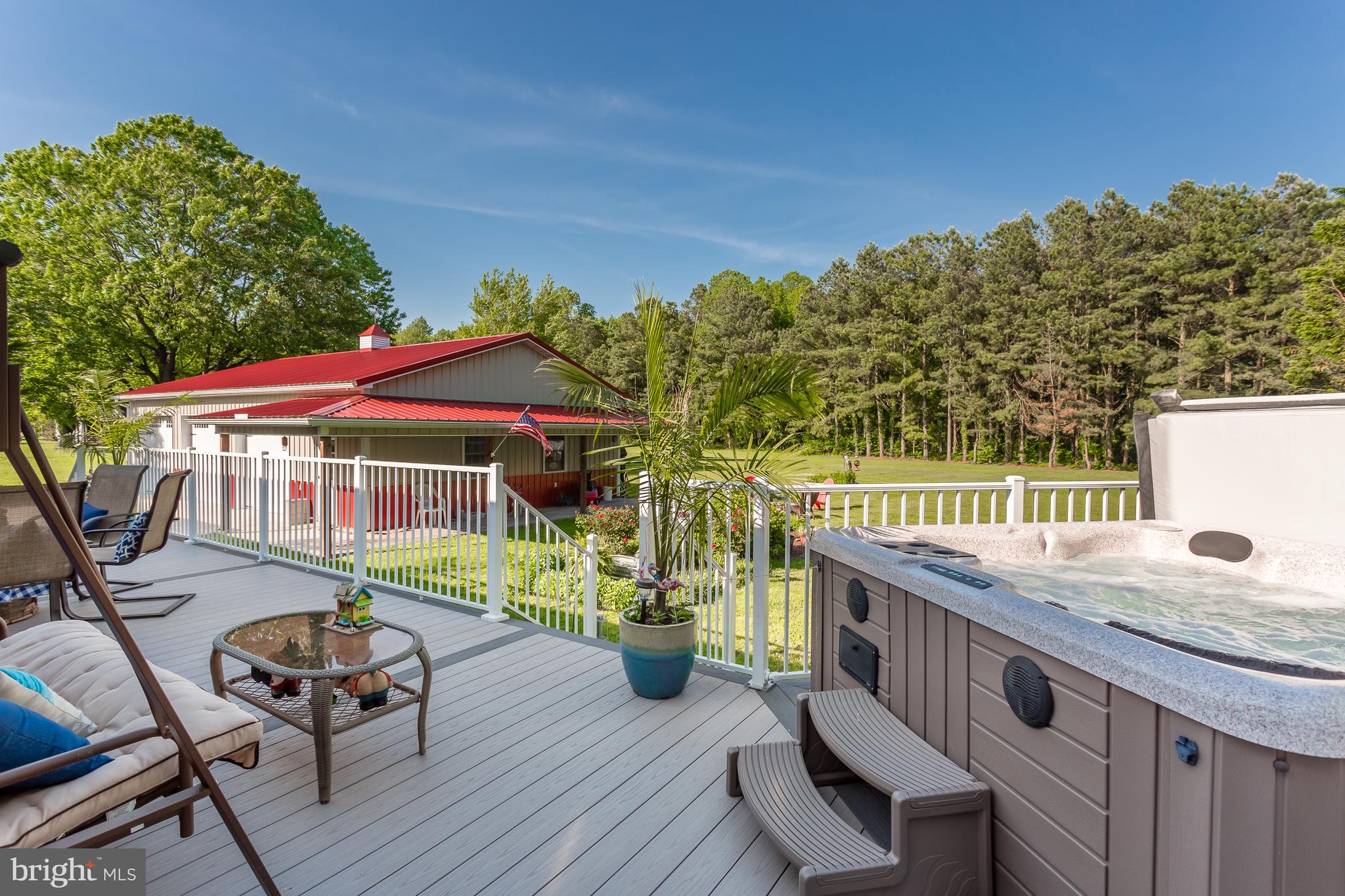 20405 Bucks Branch Road Bridgeville, DE 19933 - Photo 37 of 56 COMPOSITE DECK WITH HOT TUB & VIEW OF OUTBUILDING