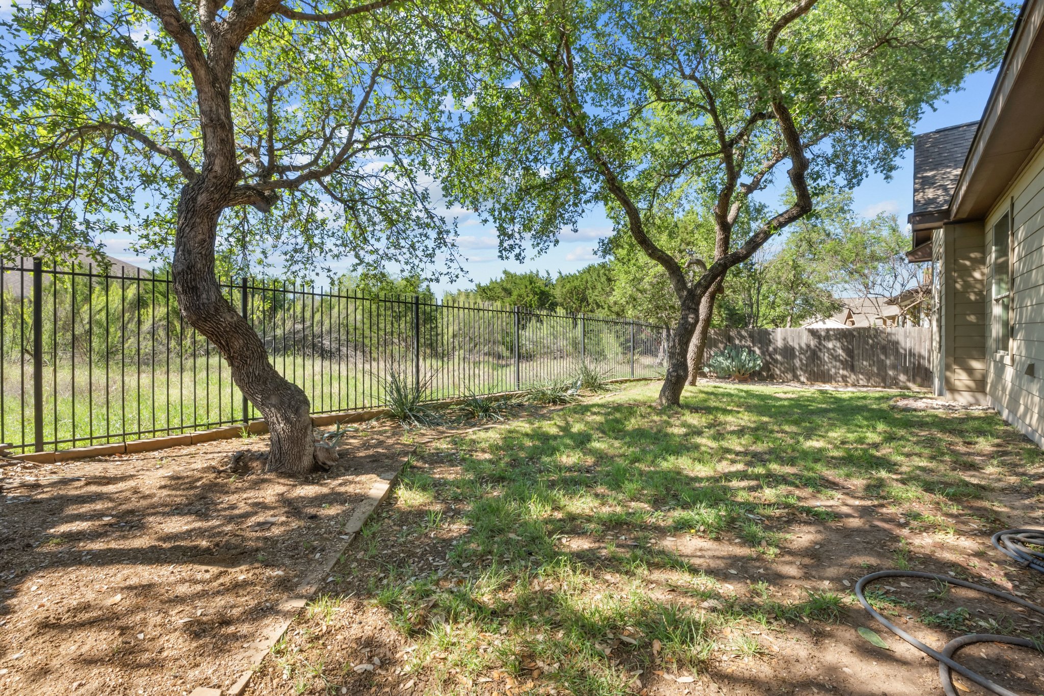 22204 Red Yucca Road Spicewood, TX 78669 - Photo 24 of 34 a view of a yard with a tree