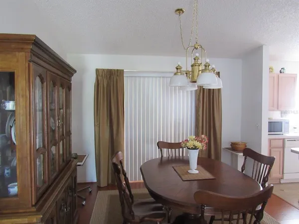 a view of a dining room with furniture and window