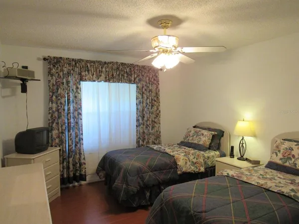 a bedroom with two beds and a chandelier
