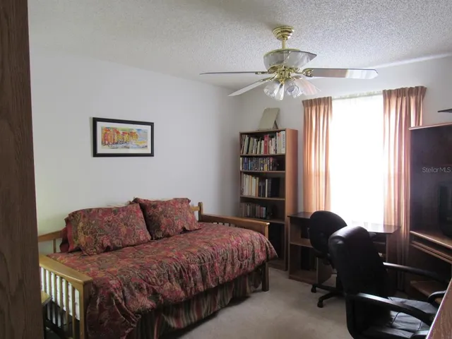 a bedroom with a bed dresser and a window