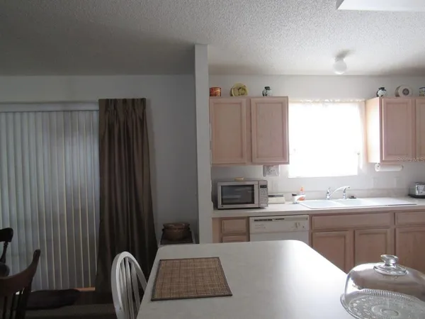 a kitchen with a sink appliances and cabinets