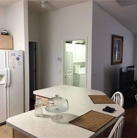 a bedroom with a bed and dresser with mirror