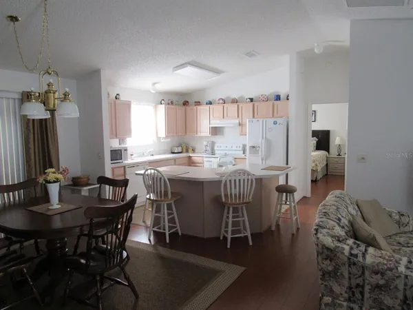 a dining room with furniture and wooden floor