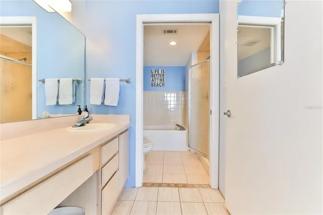 a en suite bathroom with a double vanity sink and a mirror