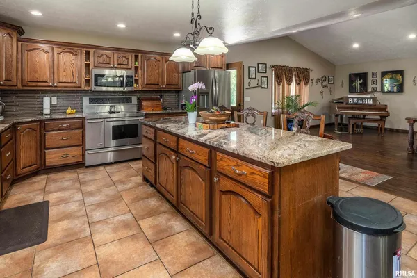 a kitchen with stainless steel appliances granite countertop a sink stove and cabinets