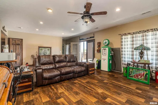 a living room with furniture a ceiling fan and a rug